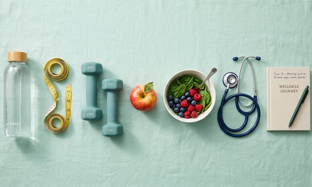 Healthy lifestyle items arranged on a mint background